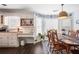 Sunlit dining area with a built-in desk, wooden table and chairs, and a blue accent wall with decorative plates at 6011 Fairlong Nw Ct, Acworth, GA 30101