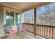 Relaxing covered balcony with wooded view and comfortable seating at 1803 Stone Bridge Way, Marietta, GA 30064
