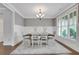 Bright dining room with large windows, stylish table, and elegant chandelier at 1803 Stone Bridge Way, Marietta, GA 30064