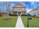 Charming two-story home featuring a manicured lawn and inviting front porch, perfect for a Gathering at 1803 Stone Bridge Way, Marietta, GA 30064