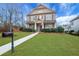 Two-story home boasts beautiful landscaping, green lawn, and inviting walkway to the front door at 1803 Stone Bridge Way, Marietta, GA 30064