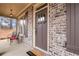 Cozy front porch with brick accents, featuring a stylish door and outdoor seating at 1803 Stone Bridge Way, Marietta, GA 30064