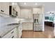 Kitchen featuring stainless steel appliances, granite countertops and seamless access to the living room at 1803 Stone Bridge Way, Marietta, GA 30064
