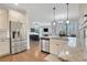 Open kitchen and living space offers stainless appliances, granite counters, and seamless entertaining at 1803 Stone Bridge Way, Marietta, GA 30064