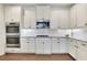 Modern kitchen featuring stainless steel appliances, granite countertops, and white cabinets at 1803 Stone Bridge Way, Marietta, GA 30064