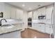 Bright kitchen featuring stainless steel appliances, white cabinets, and granite countertops at 1803 Stone Bridge Way, Marietta, GA 30064