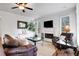 Living room featuring a fireplace, mounted tv, ample seating, and neutral decor at 1803 Stone Bridge Way, Marietta, GA 30064