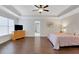 Spacious main bedroom features hardwood floors, tray ceilings, and a ceiling fan at 1803 Stone Bridge Way, Marietta, GA 30064