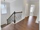 Staircase with hardwood steps and decorative wrought iron banister at 1803 Stone Bridge Way, Marietta, GA 30064