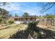 Backyard view featuring a wooden privacy fence, lush lawn, and mature trees at 2131 Columbia Dr, Decatur, GA 30032