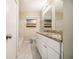 Bathroom featuring a double vanity, granite countertops, and a tile shower at 2131 Columbia Dr, Decatur, GA 30032