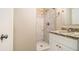 This bathroom features a single vanity with granite countertops and tile shower at 2131 Columbia Dr, Decatur, GA 30032
