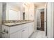 Bathroom featuring dual sink vanity with granite countertops and tiled floors at 2131 Columbia Dr, Decatur, GA 30032