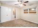 Bedroom with ceiling fan, carpet, window, closet, and bathroom at 2131 Columbia Dr, Decatur, GA 30032