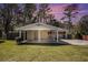 Beautifully maintained single-story home with a carport and lush green lawn at dusk at 2131 Columbia Dr, Decatur, GA 30032