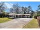 Charming single-story home featuring a carport, long driveway, and well-maintained front lawn at 2131 Columbia Dr, Decatur, GA 30032