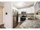 Modern kitchen with stainless steel appliances, granite countertops and white cabinetry at 2131 Columbia Dr, Decatur, GA 30032