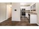 Cozy kitchen featuring stainless steel appliances, granite countertops, and dark wood-look flooring at 2131 Columbia Dr, Decatur, GA 30032