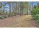 Expansive backyard with trees and wooden perimeter fence, perfect for outdoor activities at 2290 Dragonfly Nw Ct, Acworth, GA 30101