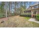 Spacious backyard with mature trees, a wooden fence, and a deck attached to the house at 2290 Dragonfly Nw Ct, Acworth, GA 30101