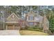 Stunning two-story home featuring a stone and siding exterior, two-car garage, and professionally landscaped yard at 2290 Dragonfly Nw Ct, Acworth, GA 30101