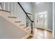 Light-filled foyer featuring hardwood floors, staircase, and a front door with decorative glass, creating an elegant entrance at 2290 Dragonfly Nw Ct, Acworth, GA 30101