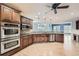 Modern kitchen featuring dark wood cabinetry, stainless steel appliances, and hardwood floors, perfect for cooking at 2290 Dragonfly Nw Ct, Acworth, GA 30101
