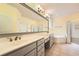 Bathroom featuring double vanity sinks, a soaking tub, and a glass enclosed shower at 2290 Dragonfly Nw Ct, Acworth, GA 30101