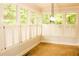 Bright sunroom featuring multiple windows with white shutters and warm tile flooring at 2290 Dragonfly Nw Ct, Acworth, GA 30101
