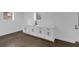 Basement wet bar area featuring modern white cabinets, sleek hardware, and attractive dark hardwood flooring at 2430 Hanford Sw Dr, Atlanta, GA 30315