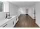 Finished basement boasts white walls, hardwood floors, sleek wet bar, and access to the stairs at 2430 Hanford Sw Dr, Atlanta, GA 30315