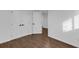 Spacious bedroom with hardwood flooring, closet, and an open doorway to another room at 2430 Hanford Sw Dr, Atlanta, GA 30315