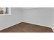 Bedroom features hardwood flooring, white walls, and a window overlooking the yard at 2430 Hanford Sw Dr, Atlanta, GA 30315