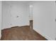 Hallway with hardwood flooring, white walls, and a closed door to another room at 2430 Hanford Sw Dr, Atlanta, GA 30315