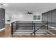 Living room overlooking kitchen with hardwood floors and modern railing at 2430 Hanford Sw Dr, Atlanta, GA 30315