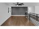 Spacious living room features hardwood floors, ceiling fan, and dark accent wall at 2430 Hanford Sw Dr, Atlanta, GA 30315