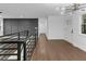 Inviting living space with hardwood floors, staircase railing, and a modern light fixture at 2430 Hanford Sw Dr, Atlanta, GA 30315