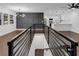 Open-concept living space with modern lighting, sleek railings, and hardwood floors at 2430 Hanford Sw Dr, Atlanta, GA 30315