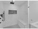 Modern shower boasts sleek marble tiles, bench seating, and stylish black fixtures at 2430 Hanford Sw Dr, Atlanta, GA 30315