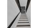 View of the staircase with hardwood steps and black metal railings at 2430 Hanford Sw Dr, Atlanta, GA 30315