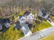 An aerial view showing a beautifully landscaped home, neighborhood, and surrounding greenery at 210 Barrett Springs Way, Canton, GA 30115