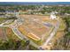 Aerial view of a new construction site with roads, lots, and community features in a developing neighborhood at 210 Barrett Springs Way, Canton, GA 30115