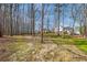 Picturesque backyard with play equipment and mature trees at 210 Barrett Springs Way, Canton, GA 30115