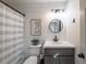 Clean bathroom with shiplap, modern vanity and decor at 210 Barrett Springs Way, Canton, GA 30115