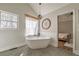 Bright bathroom with a modern tub, a decorative window, and neutral tones at 210 Barrett Springs Way, Canton, GA 30115