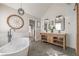 Stylish bathroom featuring a freestanding tub, double vanity, and hexagonal tile flooring at 210 Barrett Springs Way, Canton, GA 30115