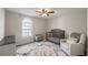 Cozy bedroom featuring a crib, soft rug, and comfortable armchair at 210 Barrett Springs Way, Canton, GA 30115