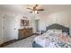 Bright bedroom with a patterned bedspread, ceiling fan and decor at 210 Barrett Springs Way, Canton, GA 30115
