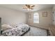Comfortable bedroom with a patterned bedspread, natural light and decor at 210 Barrett Springs Way, Canton, GA 30115