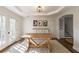 Sunlit dining area featuring wood flooring, white walls, and a rustic wooden table at 210 Barrett Springs Way, Canton, GA 30115